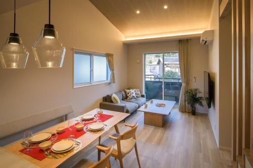 a kitchen and living room with a table and chairs at TEMARI Premier NORTH in Hakone