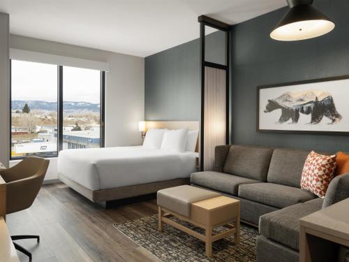 a hotel room with a bed and a couch at Hyatt Place Casper in Casper