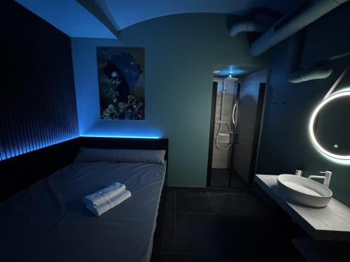 a bathroom with a blue lighting and a sink at SPA SPA Petrská hostel in Prague