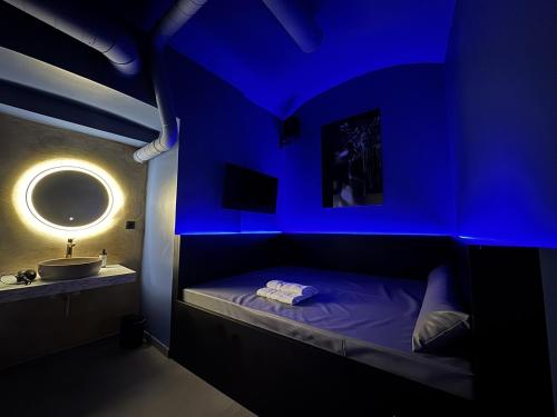 a blue room with a bed and a sink at SPA SPA Petrská hostel in Prague