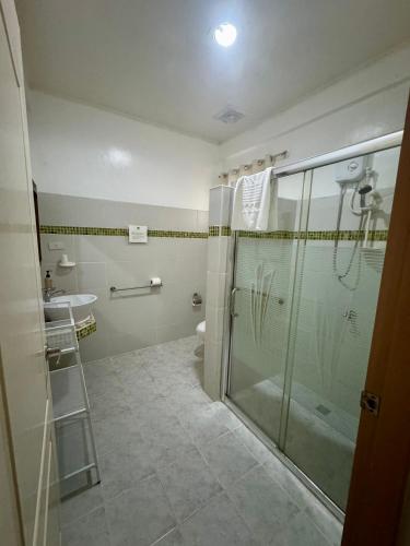 a bathroom with a shower and a sink at La Natura Resort in Coron