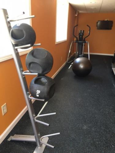a room with a gym with two exercise equipment at Days Inn by Wyndham Queensbury/Lake George in Queensbury