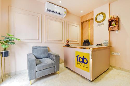 a office with a chair and a desk with a clock at FabHotel Blooming Beds Pearl in Jaipur