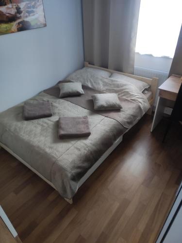 a bed with two pillows on it in a bedroom at Apartament Bieszczady in Lesko