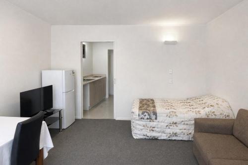 a hotel room with a bed and a couch at Ascot On Fenton in Rotorua