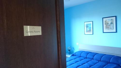 a room with a bed and a door with a sign on it at B&B Verde Irpinia in Gesualdo