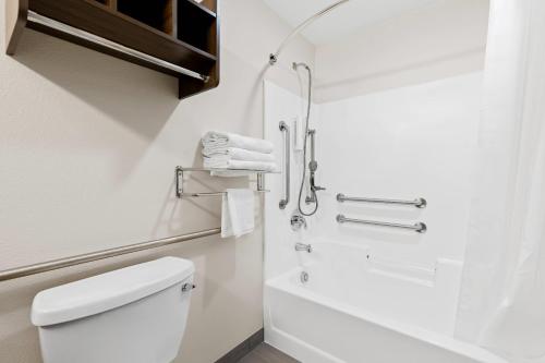 a bathroom with a toilet and a shower at Clarion Pointe Milwaukee Airport in Milwaukee