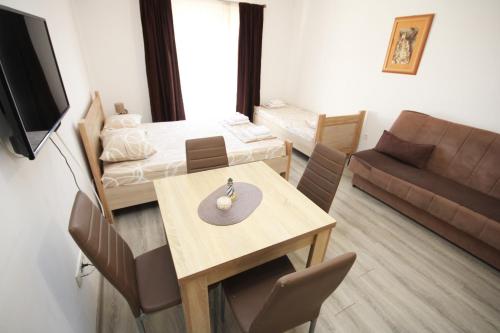 a room with a dining table and a living room at Apartments KA-7 in Podgorica