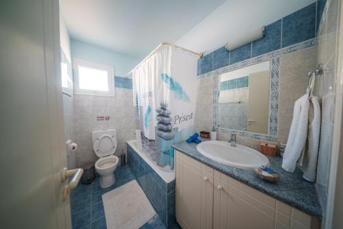 a bathroom with a sink and a toilet at The Blue Mile w Jacuzzi in Paralimni