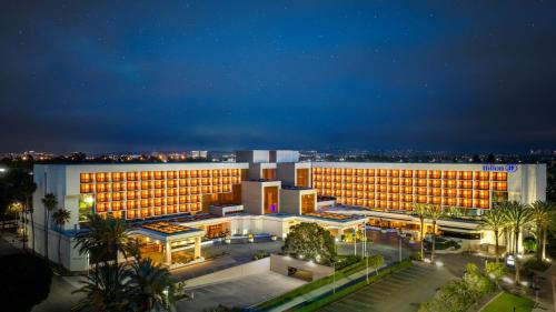 a large building with lights on in a city at night at Hilton Orange County/Costa Mesa in Costa Mesa