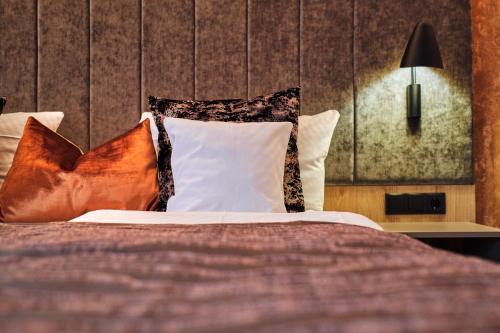 a bedroom with a bed with pillows at Parkhotel Altmühltal in Gunzenhausen