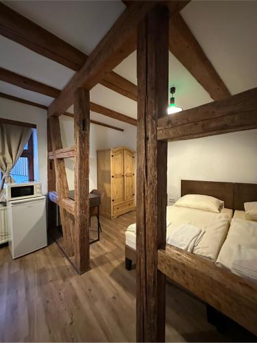 a bedroom with a large bed with wooden beams at Gästehaus Anker in Dinkelsbühl