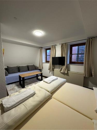 a living room with two beds and a couch at Gästehaus Anker in Dinkelsbühl