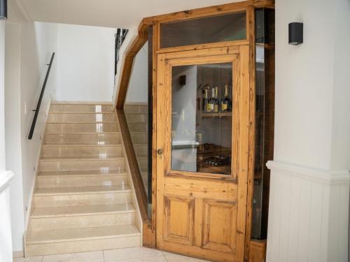 a wooden door leading up to a stairs with wine bottles at Oniro Guest House in Bedfordview