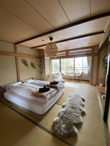 a bedroom with a large bed in a room at Seifuso At Myoko in Myoko