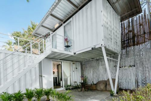 a house with a staircase on the side of it at serene hotel in Chiang Mai
