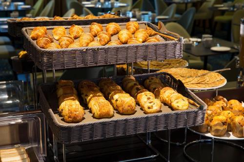 a display of trays of pastries and other pastries at Hôtel Oceania Le Métropole in Montpellier