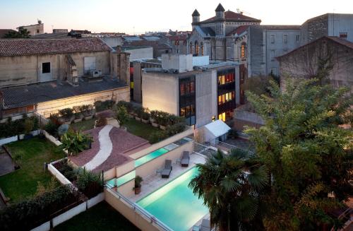 an aerial view of a building with a swimming pool at Hôtel Oceania Le Métropole in Montpellier