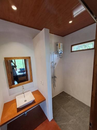 a bathroom with a sink and a mirror at Rinjani Vibe Bungalows in Tetebatu