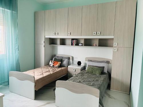 a room with two beds and cabinets in it at A casa di Ro 2 in Nola
