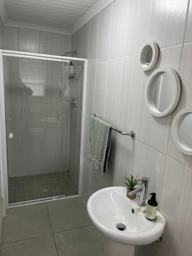 a white bathroom with a shower and a sink at Cozy at Cedarwood in Oakdale