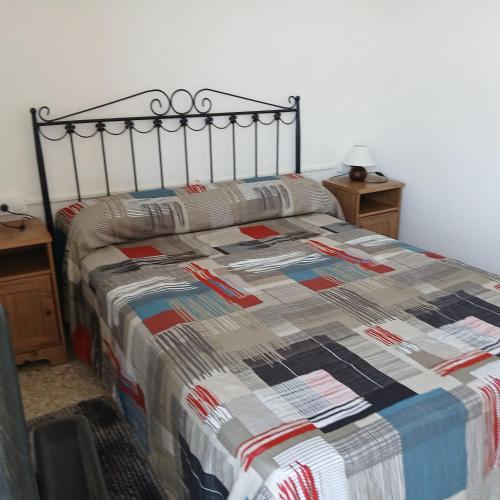 a bed with a quilt on it in a bedroom at Mar y Sol in Calafell