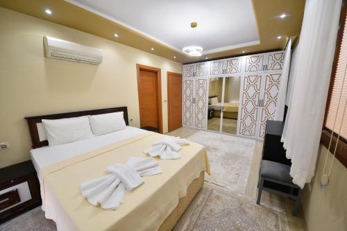 a bedroom with a bed with white towels on it at Gold villa in Fethiye