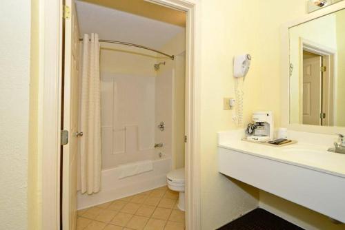a bathroom with a sink and a toilet and a shower at Manchester Heritage Inn & Suites in Manchester
