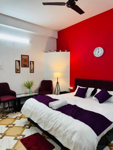 a bedroom with a large bed with a red wall at Nibha Homestay Near Guwahati Railway station 2BHK in Guwahati