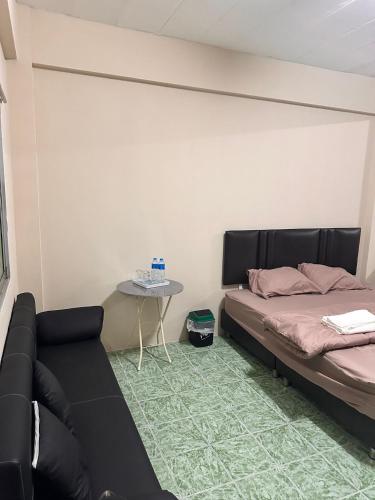 a living room with a bed and a table at Nana's Apartment in Pattaya
