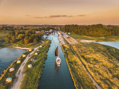 an aerial view of a canal with a boat at Marina Martinshafen - Beach life in Sassnitz