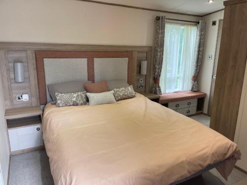 a bedroom with a large bed and a window at The Royal Oak - Sleeps 4 - Deck - Free Parking in Holsworthy
