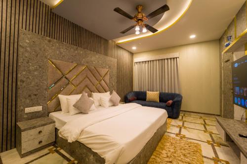 a bedroom with a bed and a ceiling fan at Lumira Queensbury Villa in Udaipur