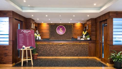 a hotel lobby with a counter and a sign at Yashshree Sanderling Mall Road in Darjeeling