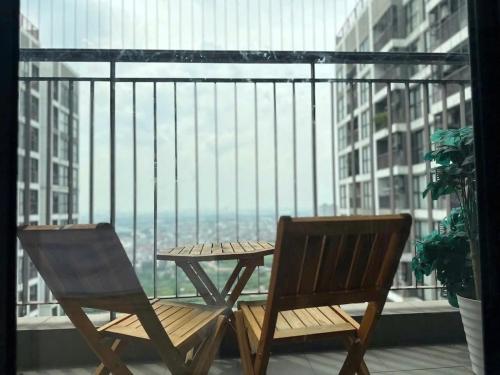 two chairs and a table on a balcony with a view at R1 Studio Ruby Zenpark in Gia Lâm Pho