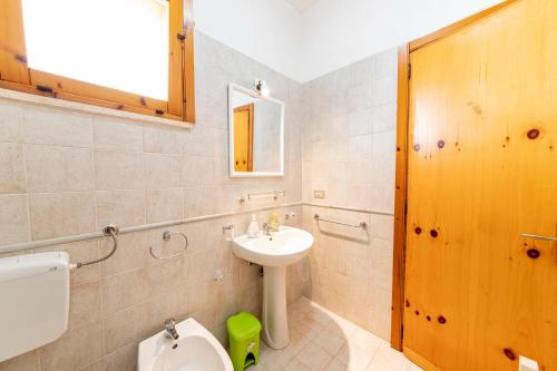 a bathroom with a sink and a toilet at Summer Flat - San Foca in San Foca