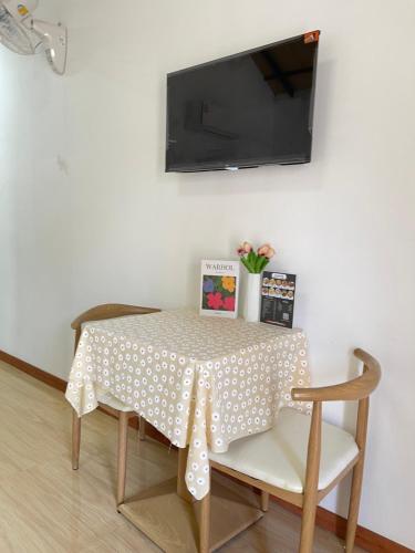 a dining room table with a polka dot table cloth at โรงแรมสบายดีรีสอร์ท in Tha Bo