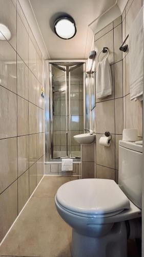a bathroom with a toilet and a sink at West Cromwell Hotel in London