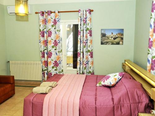 a bedroom with a pink bed and a window at Beit Wadih in Ghazīr