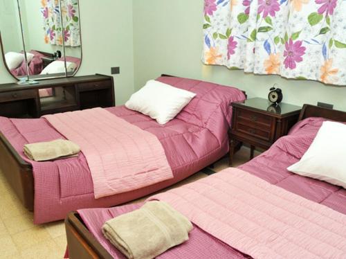 a bedroom with two beds and a mirror at Beit Wadih in Ghazīr