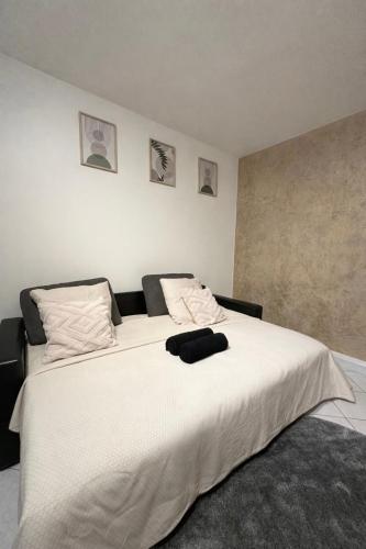 a bedroom with a large white bed with two pillows at T2 Evry Centre - Proche de Orly et Paris in Courcouronnes