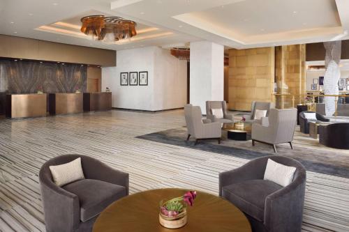 a lobby of a hotel with chairs and tables at Marriott Hotel Downtown Abu Dhabi in Abu Dhabi
