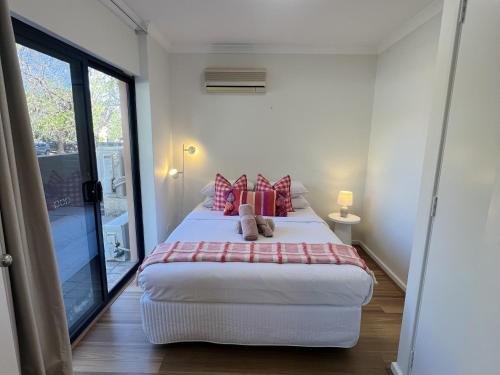 a bedroom with a bed with a teddy bear on it at REGL20/11 - East Perth Escape in Perth