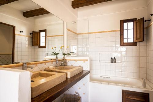 a bathroom with a large sink and a tub and a tubermott at CAN NOVES - Villa de 5 suites 58 y 15 in Sant Francesc Xavier