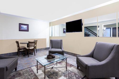 a living room with a couch and chairs and a table at Days Inn By Wyndham Bellingham WA in Bellingham