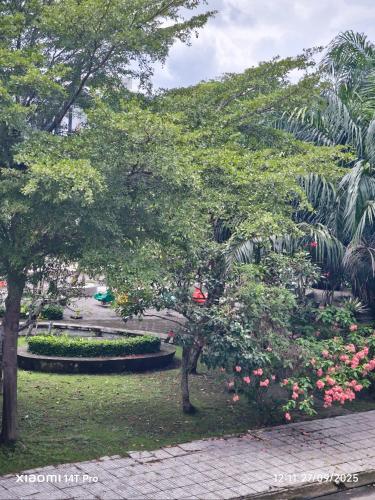 a park with trees and flowers in a park at Long Homestay Phuc An in Ðức Hòa