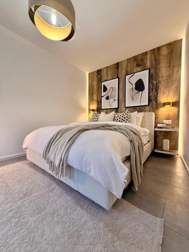 a bedroom with a large bed with a wooden headboard at Greg Rooms in Sinaia