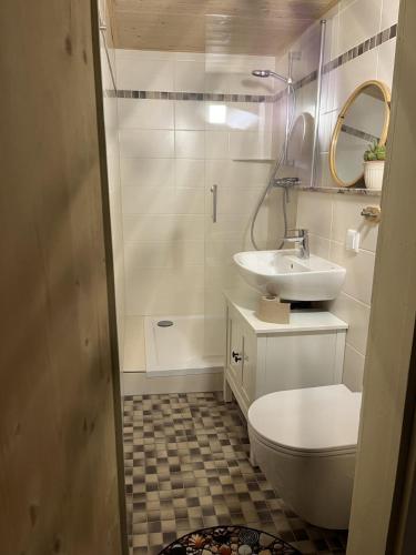 a white bathroom with a sink and a toilet at Haus Elise in Saalfeld