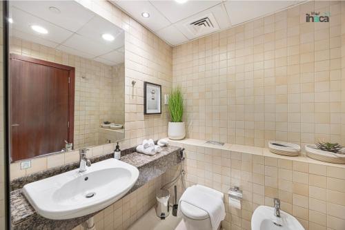 a bathroom with a sink and a toilet at 1 Br Boho Beach Ain Full Sea View JBR 1 min in Dubai