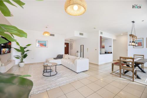 a living room with a white couch and a table at 1 Br Boho Beach Ain Full Sea View JBR 1 min in Dubai